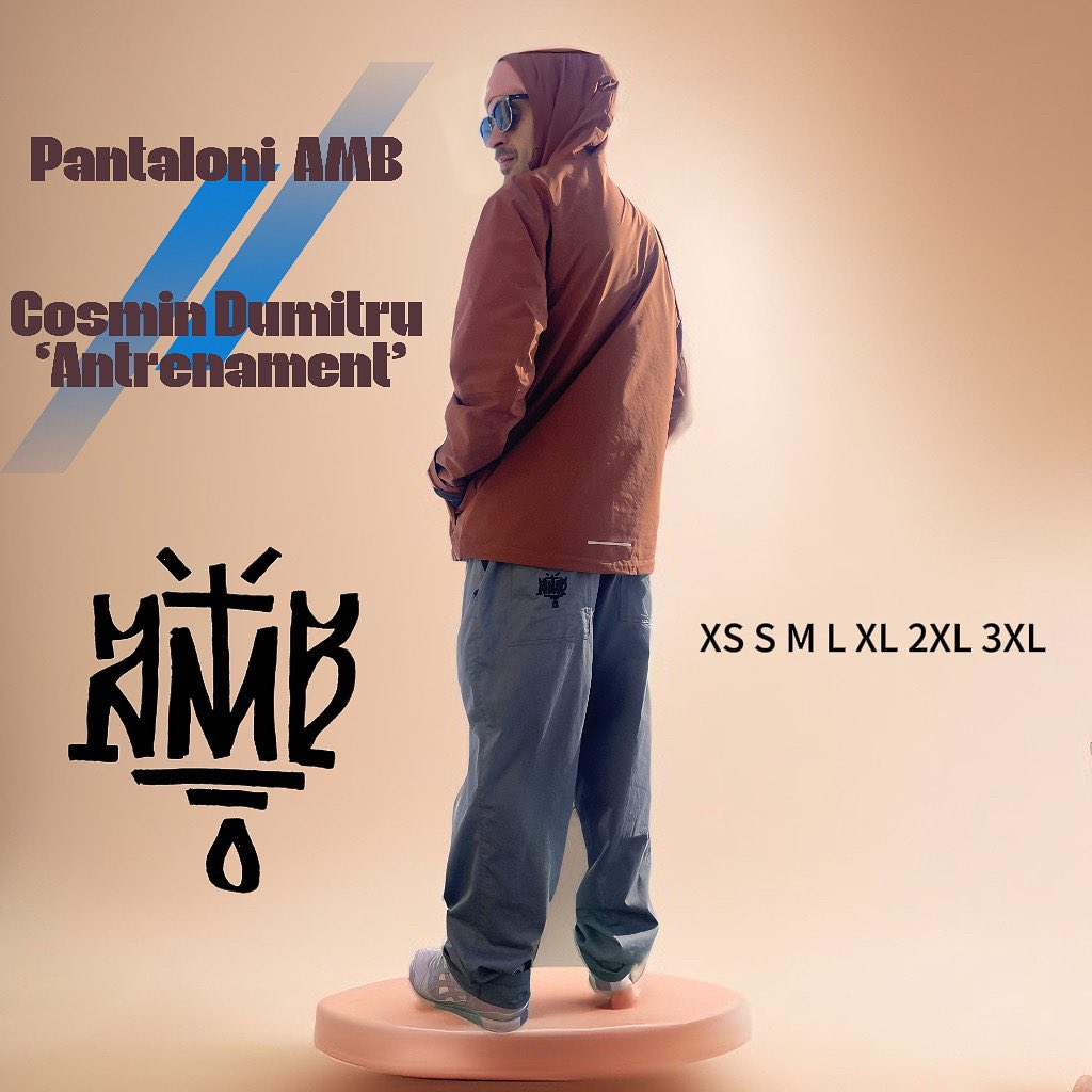 Person wearing a brown jacket and blue jeans on a beige background with 'Pantaloni AMB' branding.